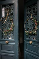 Wreaths on decorative double front doors 