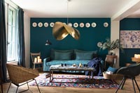 Dark blue painted living room with display of wall mounted plate 