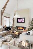 Woman relaxing in modern country living room at Christmas 
