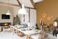 Open plan living space with dining table set for Christmas