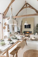 Open plan living space with dining room set for Christmas