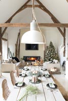 Dining table set for Christmas in open plan modern country living space 