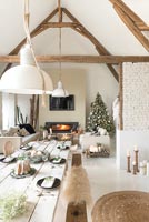 Modern country dining room set for Christmas in open plan living space 