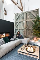Woman relaxing in living room decorated for Christmas 