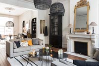 Modern monochrome living room with period details and view to dining table 