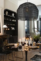 Lit candles on modern dining table 