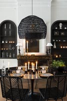 Monochrome modern dining room with lit candles 