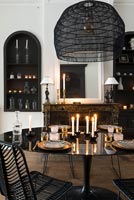 Modern black and white dining room with candles 