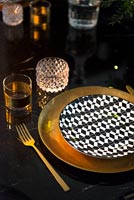 Dining room detail - black, white and gold place setting