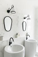 Double sinks in modern white and black bathroom 