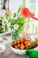 Floral display with bowl of fruit  