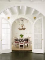 Traditional dining room through doors 