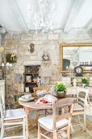 Exposed stone wall in country dining room 