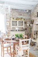 Exposed stone wall in country dining room 