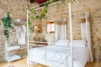 Romantic country bedroom with four poster bed 