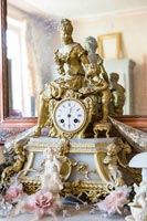 Ornate gold clock on mantelpiece 