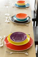 Colourful crockery on dining table 