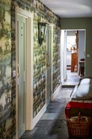 Wallpapered corridor in country house 
