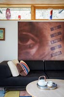 Large artwork above sofa in modern living room 