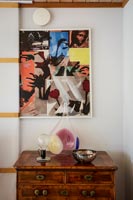 Colourful modern artwork above chest of drawers 