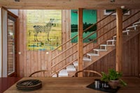 Modern wooden dining room with stairs down to room