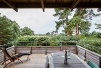 Dining table on covered decking with countryside views 