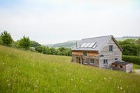 Wooden house on hillside with countryside views 