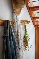 Wooden coat rack in country hallway 
