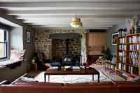 Exposed stone wall in country living room 