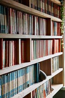 Large bookcase with collection of colour filed books 