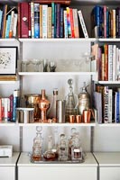 Collection of decanters and cocktail glasses on dining room sideboard