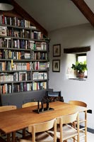 Dining area with bookcase wall 