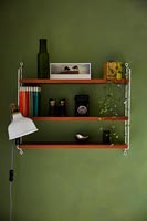 Wall mounted shelf unit with books and collectibles 