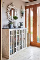 Modern country hallway with large glass fronted cabinet 