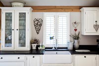 Butler sink in modern black and white country kitchen 