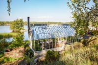 Greenhouse in garden overlooking lake 