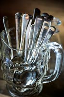 Close up jug of silver cutlery 