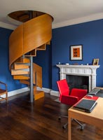 Modern spiral staircase and furniture in classic study 