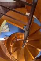 View down brushed steel and oak spiral staircase 