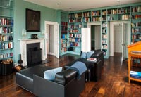Walls of blue painted bookcases in classic library 
