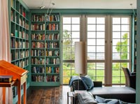 Large French windows in classic library with painted bookshelves 