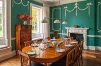 Classic dining room with green walls and original mouldings 