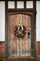 Christmas wreath on wooden front door 