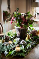 Christmas centrepiece on country dining table 