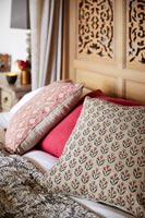 Detail of patterned cushions on bed 