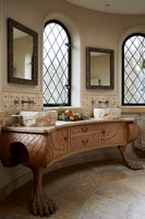 Classic bathroom with curved unit and stone sinks 
