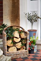 Basket of log with Christmas holly 
