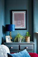 Chest of drawers in alcove of blue living room 