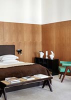Retro bedroom with wooden walls 