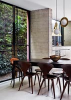 Vintage dining table and chairs in industrial open plan space 